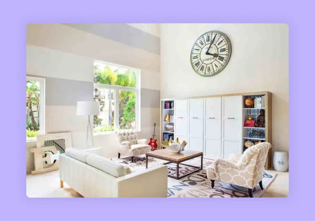 A relaxed family room with comfortable white furniture and a large decorative wall clock 