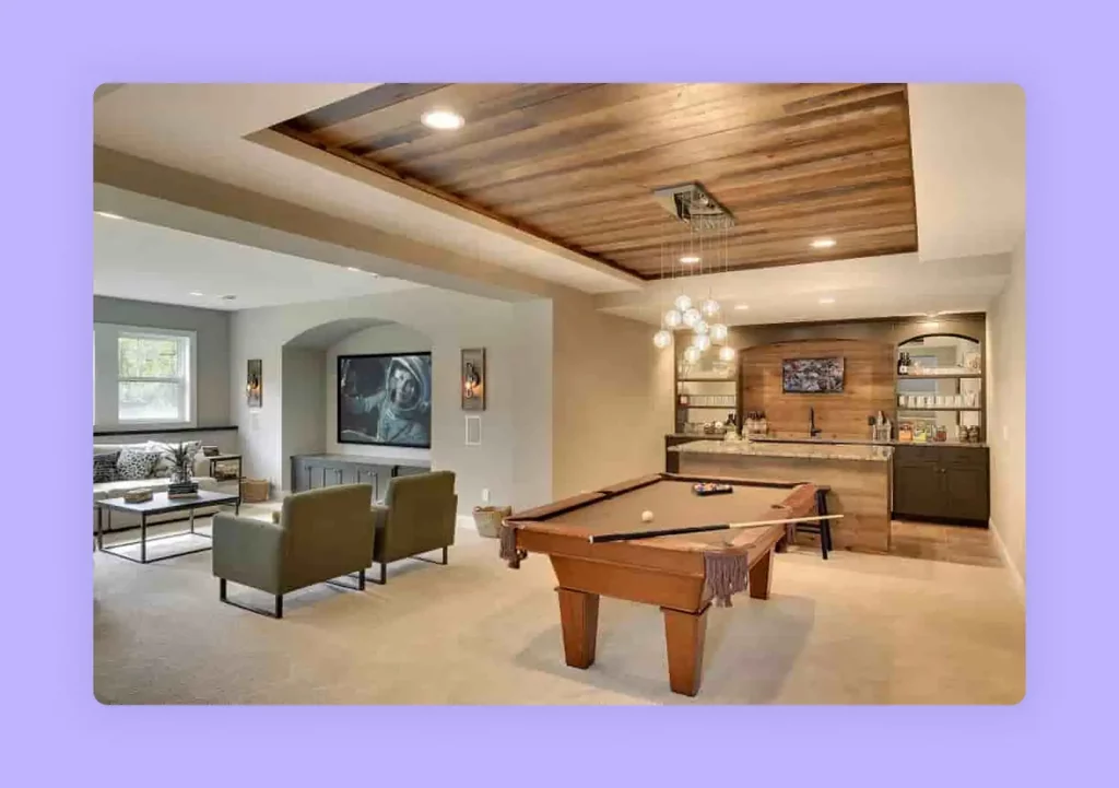 An entertainment lounge with a pool table, bar, and home theater system.