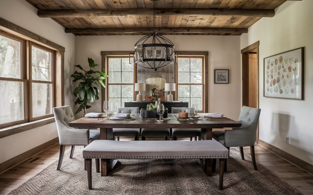 A well-lit dining room with a wooden table set for a meal.