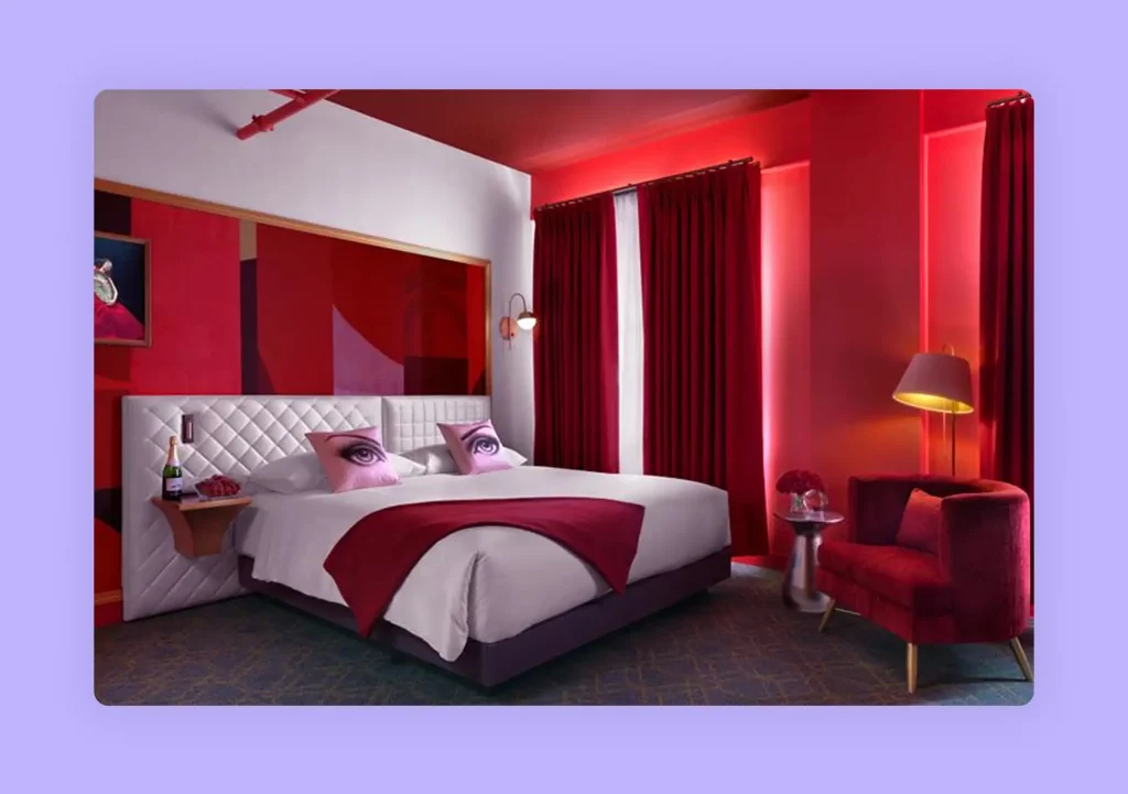 A luxurious bedroom with a bold red accent wall and matching furniture 