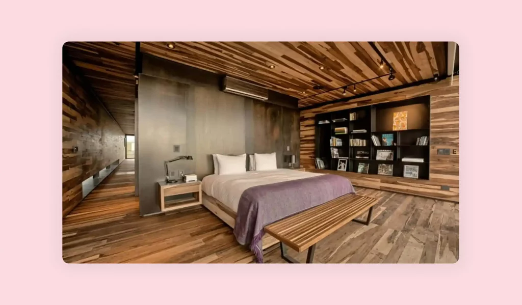 Modern bedroom design with wood plank floors and a matching wood ceiling.