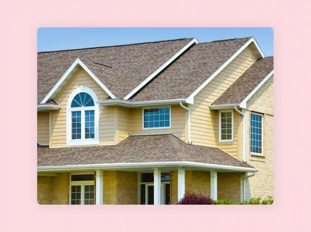 Two-story house design with beige siding and brick walls.