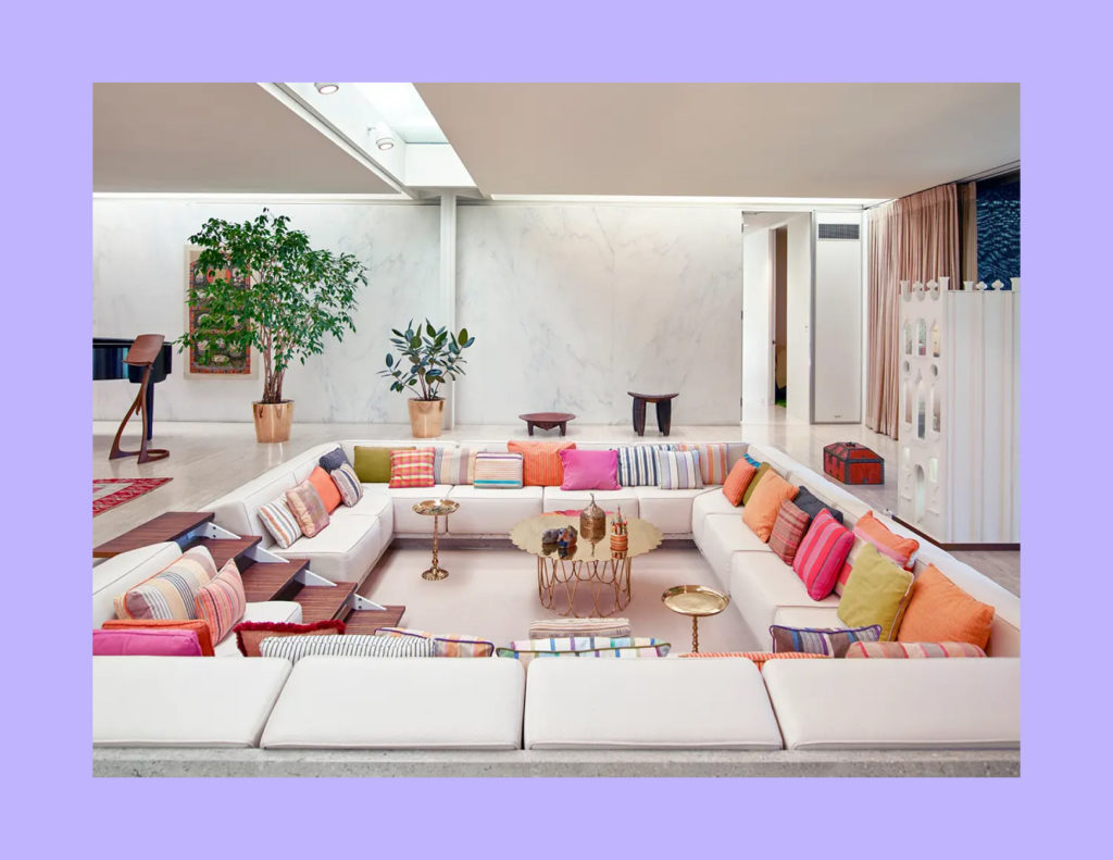A large area rug effectively grounding the main furniture arrangement in a living room. 