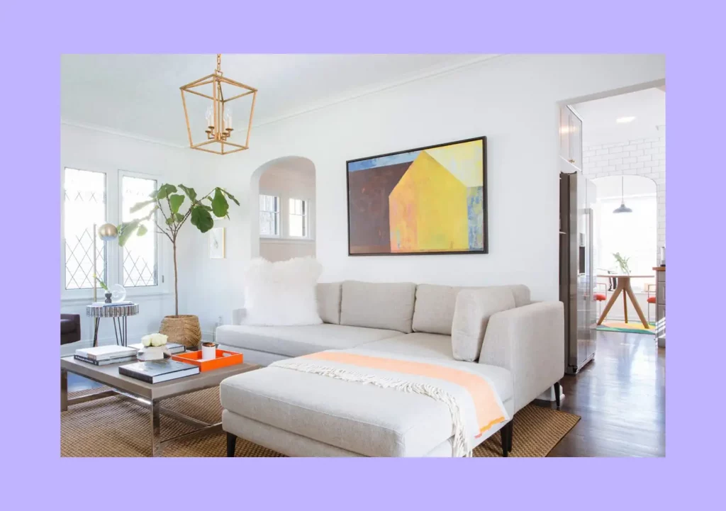 A painting hung on a wall, perfectly proportioned to the sofa beneath it.