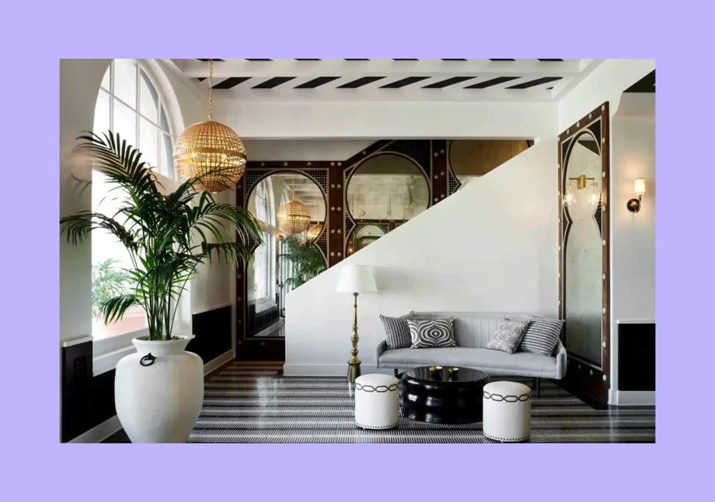 A stylish interior featuring repeating arched shapes in its mirrors, windows, and decor. 