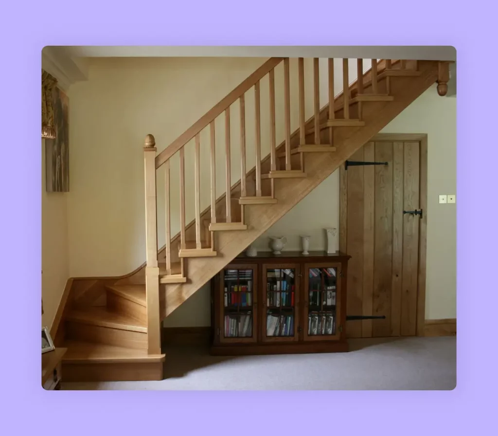 A classic wooden winder staircase design with a turn at bottom. 